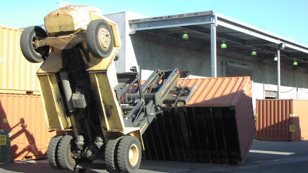 An image of a tipped over forklift with an elevated load
