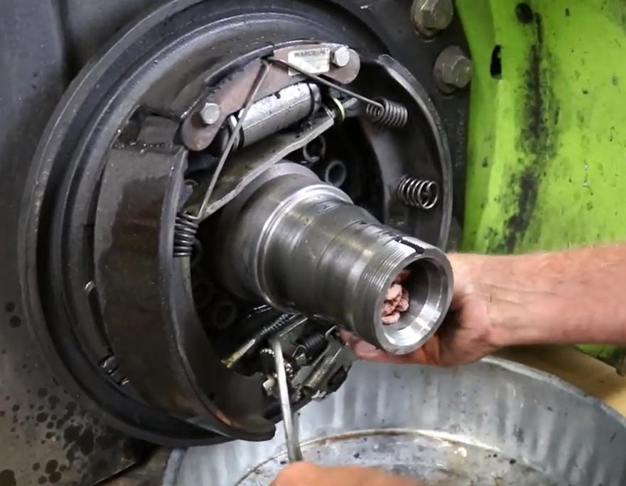 Mechanic replacing major Clark forklift brake parts