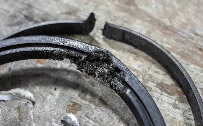 A worn and broken clark forklift tilt cylinder seal