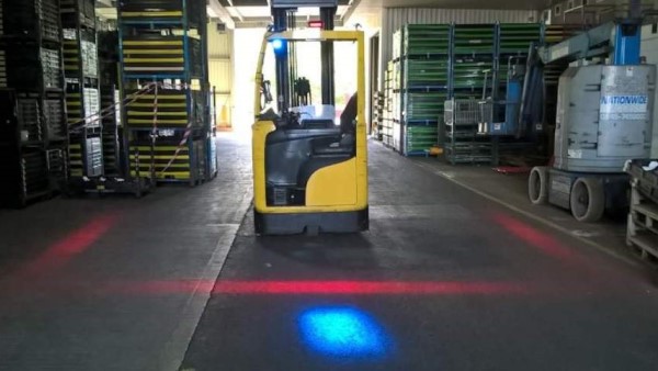 An image of a forklift with red safety lights marking the safe distance