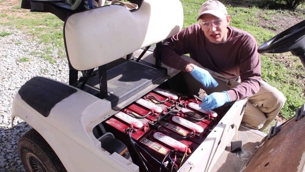 An image of an E-Z-Go golf cart battery assembly under the hood