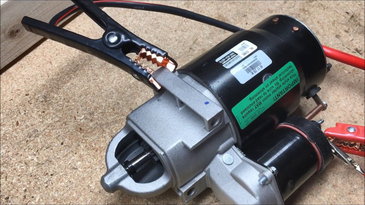 A new Mitsubishi forklift starter with battery cables attached for a cranking test