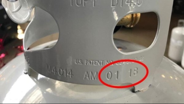 An image of a propane tank with manufacturing date stamped on it